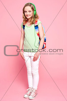 Pretty girl posing with backpack and headphone