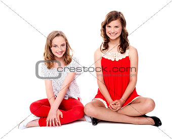 Two glamorous friends sitting together
