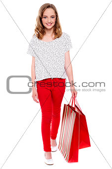 Little girl walking with shopping bag