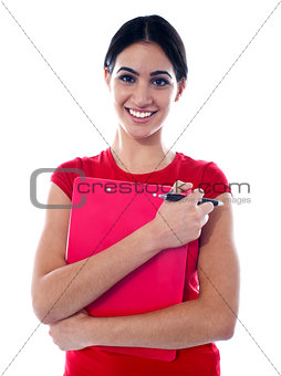 Pretty teenager holding folder and pen