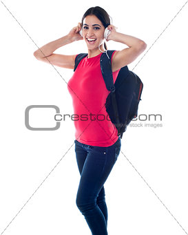College girl enjoying music through headphones