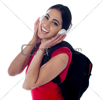 Cheerful pretty teen listening to music