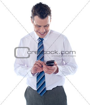 Business executive reading text message