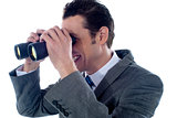 Male executive using binoculars