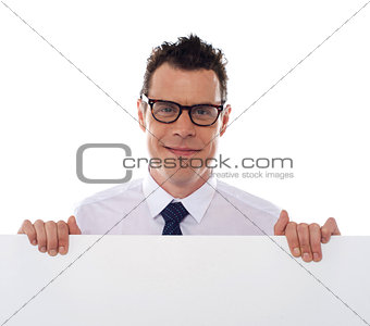 Young man holding blank billboard