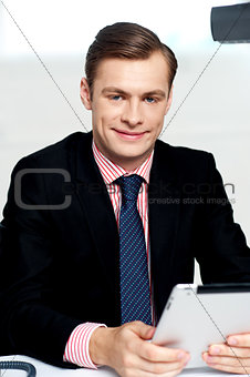 Young executive posing with tablet pc