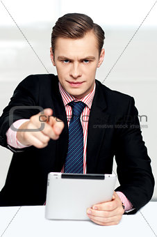 Tech savvy corporate man pointing at you
