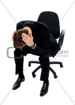 Frustrated young man sitting on chair