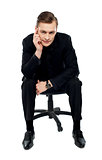 Handsome young caucasian male sitting on chair
