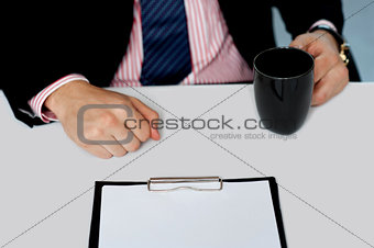 Closeup of businessman holding empty cup