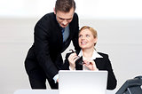 Business people at work. Male pointing at laptop