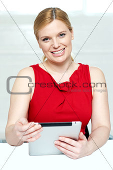 Beautiful young woman holding portable tablet pc