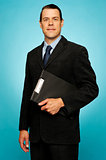 Corporate man holding clipboard and posing