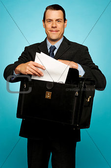 Male executive arranging paper works