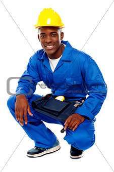 Seated african worker posing with a smile