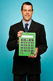 Corporate guy showing big green calculator
