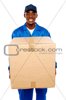 Delivery guy holding big parcel and smiling