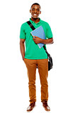 Student carrying laptop bag and notebook