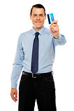 Smiling executive showing credit card
