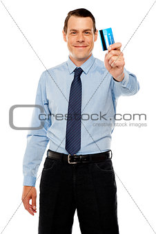 Smiling executive showing credit card