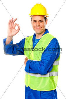Handsome young worker gesturing okay sign
