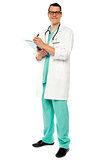 Full length portrait of doctor writing prescription