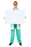 Male doctor displaying white advertising board
