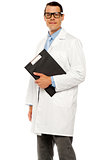 Doctor in glasses carrying clipboard