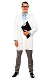 Full length shot of doctor posing with clipboard