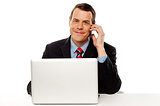 Businessman working and talking on cell phone