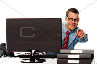 Male executive in glasses pointing at camera