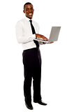 Full length portrait of businessperson holding laptop