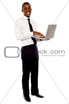 Full length portrait of businessperson holding laptop