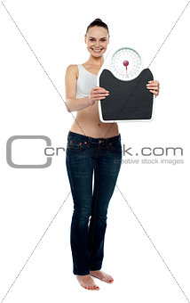 Full frame woman holding a scale