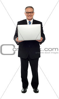 Experienced business person holding laptop