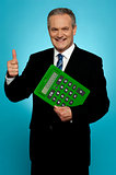 Businessman showing thumbs up, holding calculator