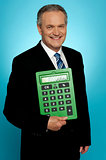 Senior executive posing with big green calculator