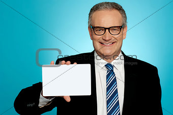 Businessman in glasses showing placard