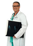 Smiling doctor carrying x-ray report of hand bone