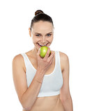 Healthy fit woman eating fresh green apple