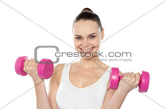 Attractive athlete exercising with dumbbells