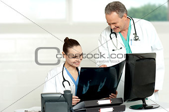 Team of surgeons discussing x-ray report