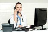 Beautiful nurse talking on phone with patient