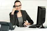Businesswoman in glasses communicating on phone