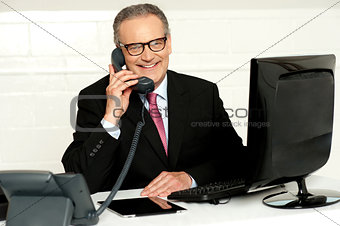 Senior businessman attending phone call