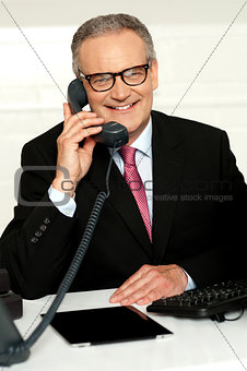 Smiling aged man communicating with his client