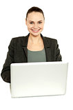 Attractive corporate female working on laptop
