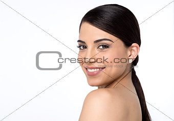 Bare shoulder woman looking into camera