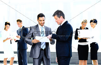 Image of business partners discussing documents