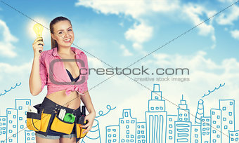 Woman in tool belt holding light bulb. Sketch buildings, chimneys as backdrop
